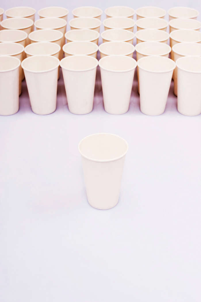 A group of paper cups with an isolated paper cup